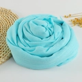 Sky blue cotton linen scarf with frayed edges in a rose shape on a white background - 190x100cm / Sky Blue