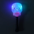 Detail view of a glowing skull magic wand with vibrant blue and pink LED light effects - Skull Magic Wand