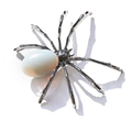Detailed close-up of spider brooch featuring silver-toned metal legs and opal stone body - Oval Opalite