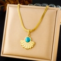 Detail of turquoise fan pendant on flat gold blade chain resting on a display mat - Fan Shape Turquoise Pendant Necklace (N3189)