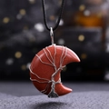 Macro shot of red goldstone moon pendant with wire-wrapped tree of life design - Gold Sandstone