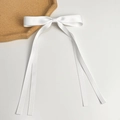 Detailed close-up of white satin bow hair clip with long ribbons on minimalist background - Long Streamer Style (Single) / White