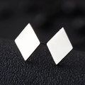Macro view showing the polished mirror finish on geometric stainless steel diamond studs - Diamond / Silver