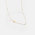 Macro detail of gold S925 silver letter A necklace with three inlaid sparkling zircon stones - Letter A / 925 Sterling Silver Plated With 18k Gold