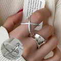 Polished silver irregular wave and X-shape cross ring set worn by model - Cross/Irregular Wave