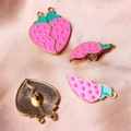 Detail of pink strawberry magnetic pendant showing split heart design and golden finish - Magnetic Pink Strawberry