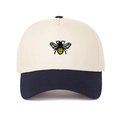 Detailed embroidery of a honey bee on a two-tone cream and navy trucker hat - Navy Blue
