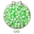 Close-up of mint green resin cat-eye round beads on a silver decorative tray for DIY jewelry - Green