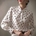 Detail of elegant polka dot shirt featuring a vintage pointed collar and lantern sleeves - S / White