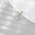 Silver crescent moon belly button ring with sparkling zircons on a white ceramic plate - Zirconia Moon Belly Button Ring