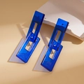 Detail of blue acrylic drop earrings with glossy finish and geometric rectangle design - Blue