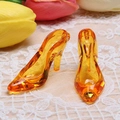 Detail of orange translucent high heel charms on lace fabric with tulip background - Orange