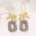 Detailed view of gold bow earrings featuring grey oval pendants with rose texture - Rose Bowknot Oval Style (A-1351) / KC Gold / Grey