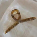 Elegant amber brown large hair claw clip with glossy finish on soft silk fabric - Glossy Coffee