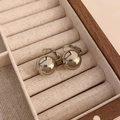 Detailed close-up of silver metallic ball earrings in a velvet jewelry box - Bright Silver Ball Hoop (58#)