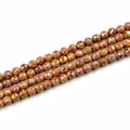 Macro detail of faceted agate beads with 10mm round cut and sparkling orange finish - 10mm / Electroplated Burgundy
