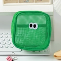 Detail of green mesh makeup bag with cartoon eye embroidery on a white keyboard - 13*7*13cm / Green