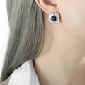 French hammered texture square earrings with black gemstone inlay on model's ear - Steel Black Glass Earrings