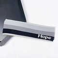 Moisture-wicking knitted sports headband in black, white, and gray stripes with Hope text - Black