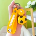 Yellow football keychain with silicone wrist strap and mini ball charm for fans - Yellow