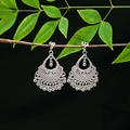 Detailed view of silver ethnic earrings with hollow patterns and tassel bells on a branch - E4948-4 (Bell Tassel)