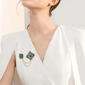 Vintage gold brooch with emerald gems and pearls worn on a white blazer outfit - Green Square Gem Pearl Style (E31933-2)