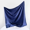 Detail of dark blue satin square scarf showing glossy silk texture on an open book - 90*90cm / Navy Blue
