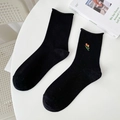 Black cotton middle tube socks with orange tulip embroidery and soft rolled cuffs - One Size / Black