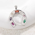 Macro shot of horseshoe pendant with multicolor gemstones in silver plating - Silver Colorful Horse Shoe