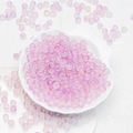 Macro shot of purple frosted beads with gold specks in a white shell dish for DIY jewelry - 8mm Light Purple with Gold Glitter