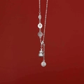 Long pearl necklace with silver gourd and fortune charms over a deep red background - Silver Gourd