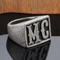 Detail shot of vintage silver punk ring with MC letter engraving on a wood surface - US 7 / Vintage Silver MC