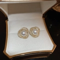 Detail of gold zircon twisted earrings with center pearl in a luxury jewelry box - Artificial Pearl & Zirconia Stud Earrings (Silver Earring Post)
