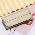 Champagne gold textured leather sunglass pouch with portable flap and strap closure - Beige