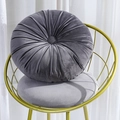 Deep grey round velvet pumpkin cushion with handcrafted pleated texture on a chair - Silver Grey