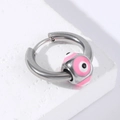 Nahaufnahme der silbernen Edelstahl-Creole mit Evil Eye Anhänger auf weißem Stein - Stahl-Rosa