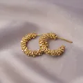 Golden C-shaped hoop earrings with textured beaded surface on purple silk background - Textured C-Shape / E-051---Gold
