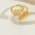 Macro detail of leaf-shaped ring with rectangular gemstones in 14K gold plating - Leaf Zircon Style