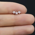 Detailed close-up of small silver triple flower ear studs with sparkling clear zircons - Silver Triple Flower