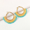 Detailed close-up of handmade bohemian seed bead fan hoop earrings with gold metal accents - Wheat