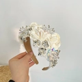 Detailed view of white fabric petals and shimmering rhinestones on the bridal headband - 3D Flower Rhinestone Headband / Beige