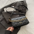 Chic black quilted crossbody bag with bold gold chain and adjustable leather strap - Black