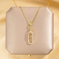 Gouden geometrische paperclip ketting met zirkonia hanger op een luxe sieradendoosje - Gouden Paperclip Ontwerp