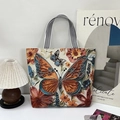 Etnische canvas shopper met 3D-vlinderborduurwerk en zwart-wit gestreepte handgreep - Vlinder