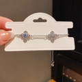 Detailed shot of silver adjustable bracelet featuring blue and clear clover charms - 36# Bracelet - Silver - Flower