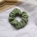 Green pleated fabric scrunchie with bow detail displayed on a clean white background - Light Green Cream Scrunchie