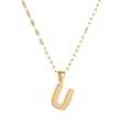 Detailed view of gold letter U pendant with embossed dot texture on a metal chain - Letter U
