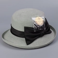Detail of straw hat texture with black bow and UPF 50+ UV protection tag info - M(56-58cm) / Grey Green