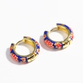 Detail of gold hoop earrings with blue enamel finish and red floral pattern on white background - Royal Blue