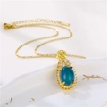 Detailed view of teardrop color-changing pendant with blue stone and gold chain - Gold with Color Changing Stone